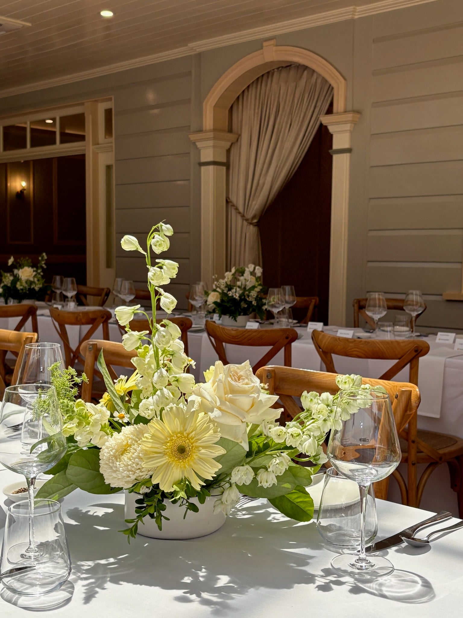 Table arrangement for a wedding at Gabbinbar homestead made up of white and yellow flowers. 